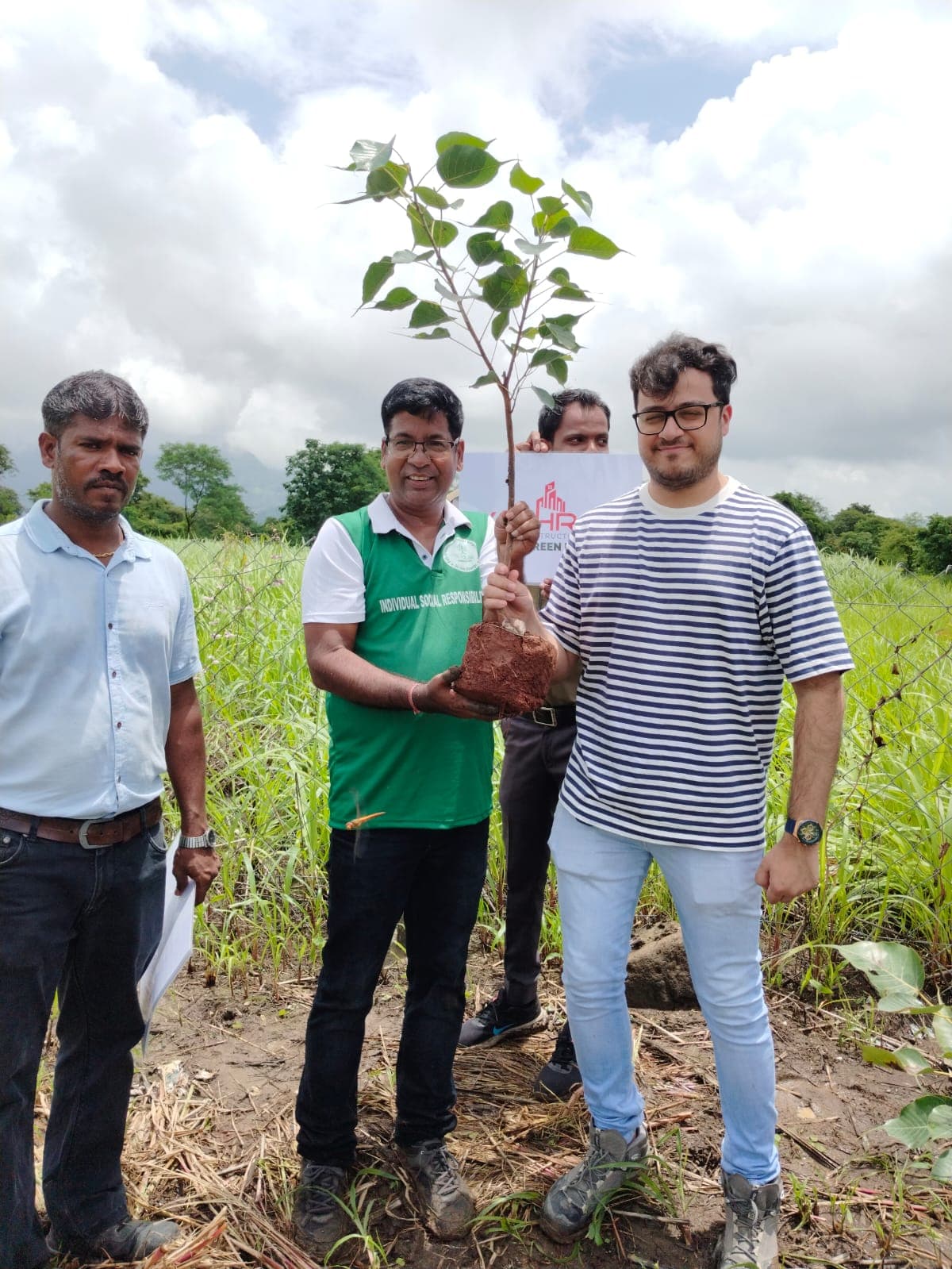 Team members at a tree plantation initiative with saplings
